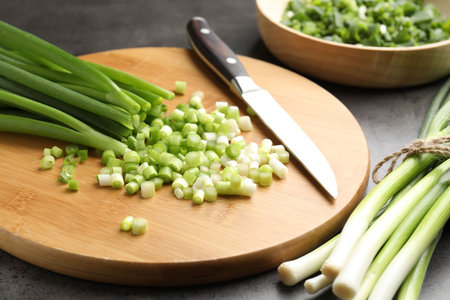 Green onions and knife on gray table, closeupの写真素材