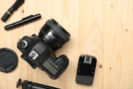 Professional photographer's equipment on wooden background, flat lay. Space for textの写真素材