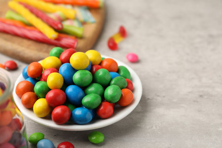 Delicious colorful candies on light table, closeup. Space for textの写真素材
