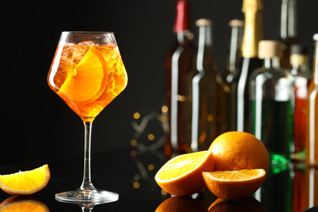 Refreshing spritzer cocktail and orange slices on table in bar. Space for textの写真素材