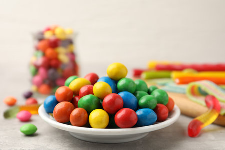 Delicious colorful candies on light table, closeup. Space for textの写真素材
