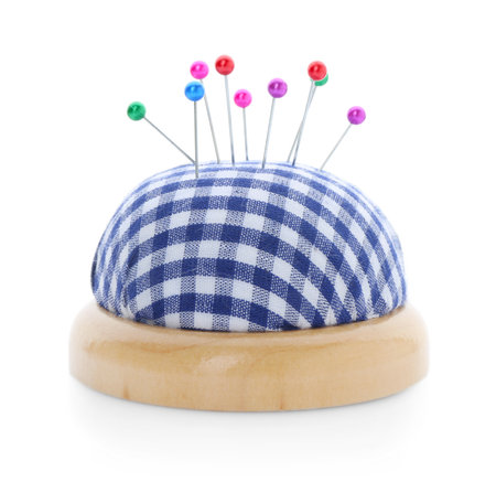 Checkered pincushion with pins isolated on white. Sewing accessoryの写真素材