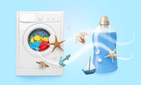 Bottle of laundry detergent or fabric softener and washing machine on light blue background. Shells, starfish for sea fresh scentの写真素材