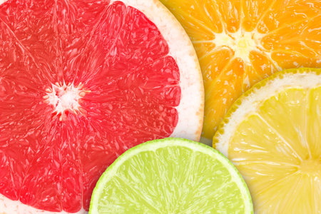Citrus fruits as background. Slices of orange, lime, lemon and grapefruit, top viewの写真素材