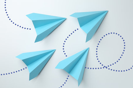Paper planes with dotted lines as air route track on white background