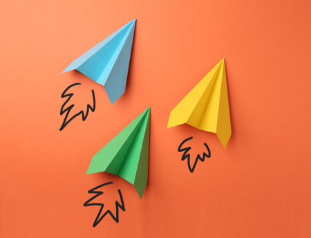Paper planes on orange backgroundの写真素材