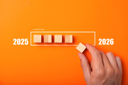 Man putting wooden cube next to others onto loading bar on orange background, top view