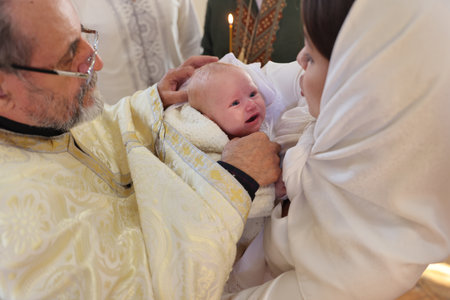 Mykolaiv, Ukraine - November 1, 2025: Priest conducting baptism ceremony in church