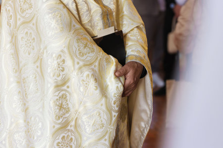 Priest with Holy Bible in church, closeup