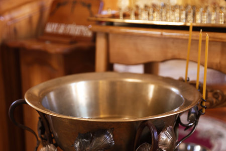 Baptismal font and wax candles in church, closeupの写真素材