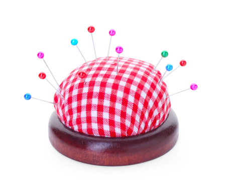 Checkered pincushion with pins isolated on white. Sewing accessoryの写真素材