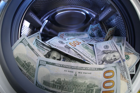 Many dollar banknotes in washing machine, closeupの写真素材