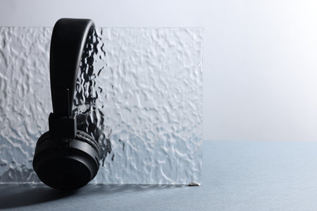 Pair of stylish headphones on gray table, closeup. Space for textの写真素材