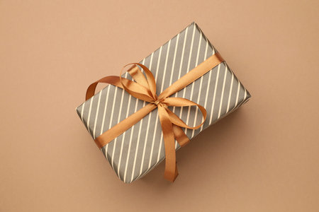 Beautiful wrapped gift on brown background, top viewの写真素材