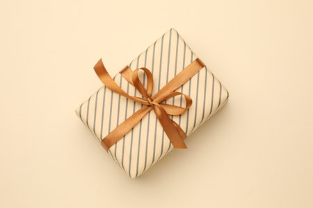 Beautiful wrapped gift on beige background, top viewの写真素材
