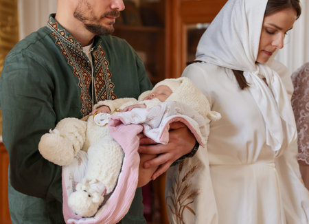 Father holding his child during baptism ceremony in church, closeup