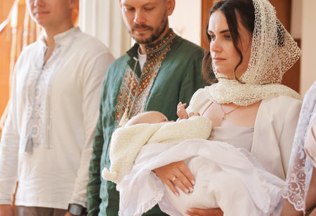 People with child during baptism ceremony in church