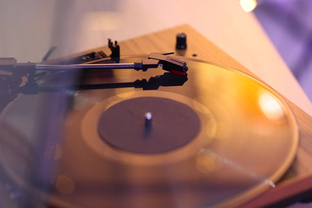 Turntable with vinyl record on table, closeup