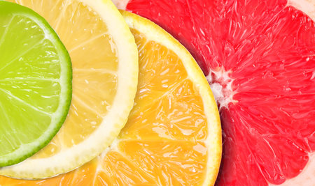 Citrus fruits as background. Slices of orange, lime, lemon and grapefruit, top viewの写真素材