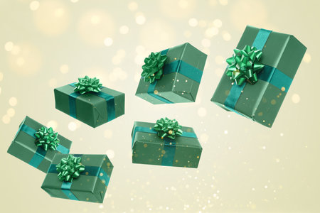 Gift boxes flying in air on gray background with bokeh lights