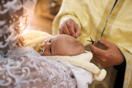 Priest conducting baptism ceremony in church, closeup