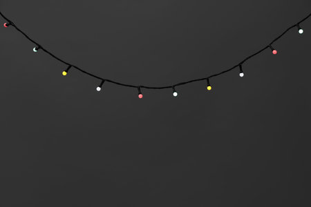Bright lights on gray background, closeup. Space for text