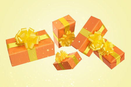 Gift boxes flying in air on yellow background with bokeh lights