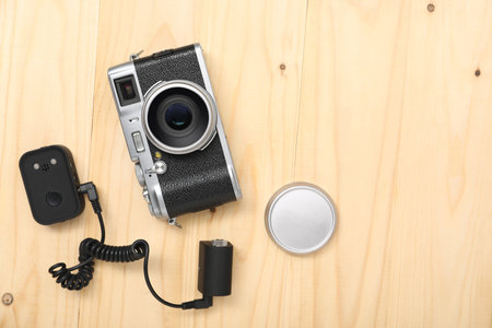 Professional photographer's equipment on wooden background, flat lay. Space for textの写真素材