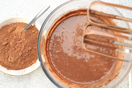 Chocolate dough and cocoa powder on gray textured table, flat lay