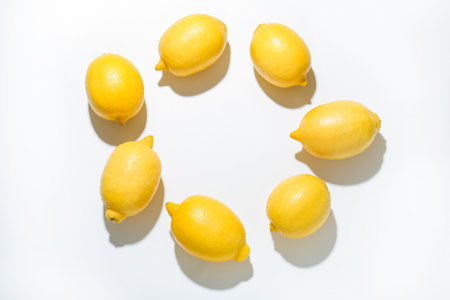 Frame made of fresh ripe lemons on white background, flat lay. Space for textの写真素材