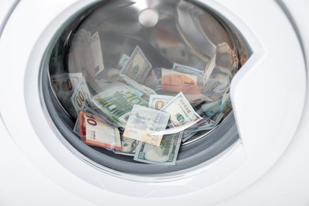 Many dollar and euro banknotes in washing machine, closeup