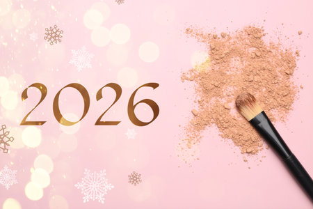 Makeup brush, crushed decorative cosmetic product and numbers 2026 on pink background, top view
