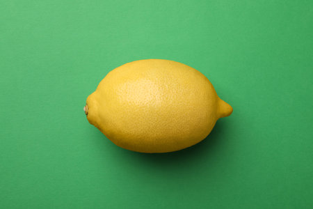 Fresh ripe lemon on green background, top viewの写真素材