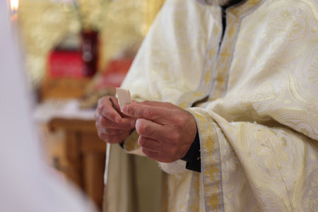 Priest holding piece of paper in church, closeup