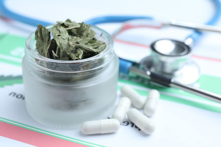 Hemp leaves, stethoscope and pills on prescription, closeup. Space for textの写真素材