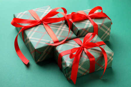 Beautiful gift boxes on green background, closeupの写真素材