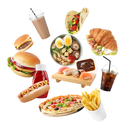 Different fast food, drinks and sauces falling on white background. Meal delivery serviceの写真素材