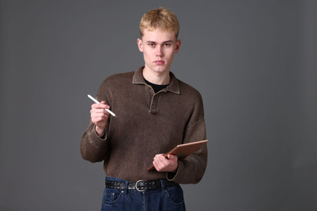 Professional designer with tablet on gray backgroundの写真素材