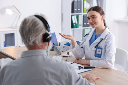 Patient with audiometric headphones undergoing hearing test in clinic, selective focusの写真素材