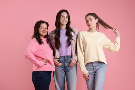 Portrait of happy friends on pink backgroundの写真素材