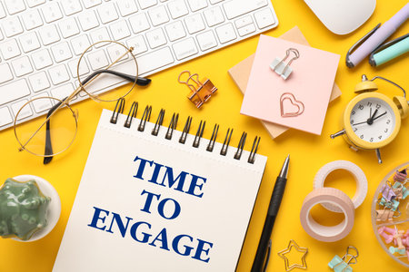 Notebook with text Time To Engage, alarm clock, computer keyboard and stationery on orange table. Flat layの写真素材