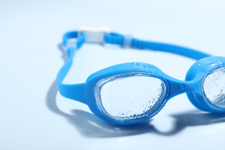 Swimming goggles on light blue background, closeupの写真素材