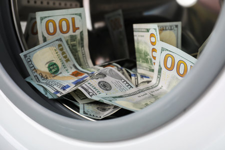Many dollar banknotes in washing machine, closeupの写真素材