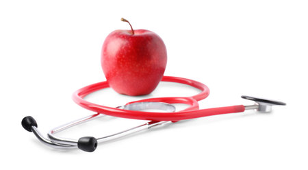 Ripe apple and stethoscope isolated on whiteの写真素材