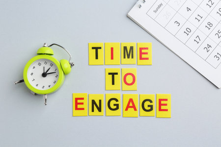 Phrase Time to engage, calendar and alarm clock on light gray background, flat layの写真素材