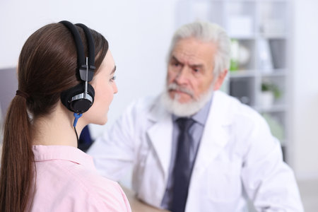 Patient with audiometric headphones undergoing hearing test in clinic, selective focusの写真素材