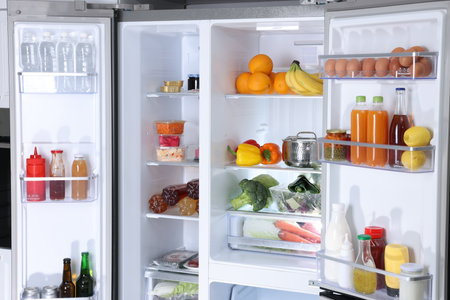Modern refrigerator with different fresh food productsの写真素材