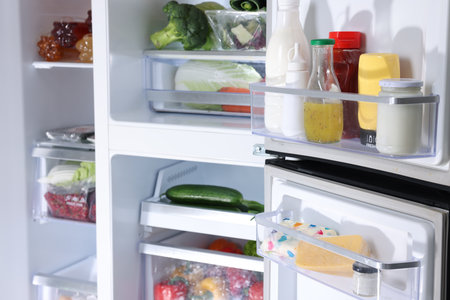 Modern refrigerator with different fresh food productsの写真素材