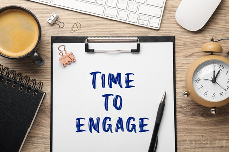 Paper with text Time To Engage, alarm clock, coffee, computer keyboard and mouse on wooden table. Flat layの写真素材