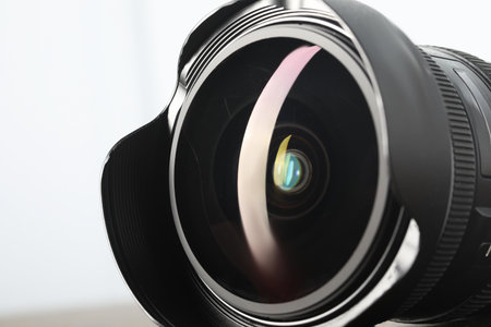 Professional camera lens on light background, closeup. Photographer's equipmentの写真素材